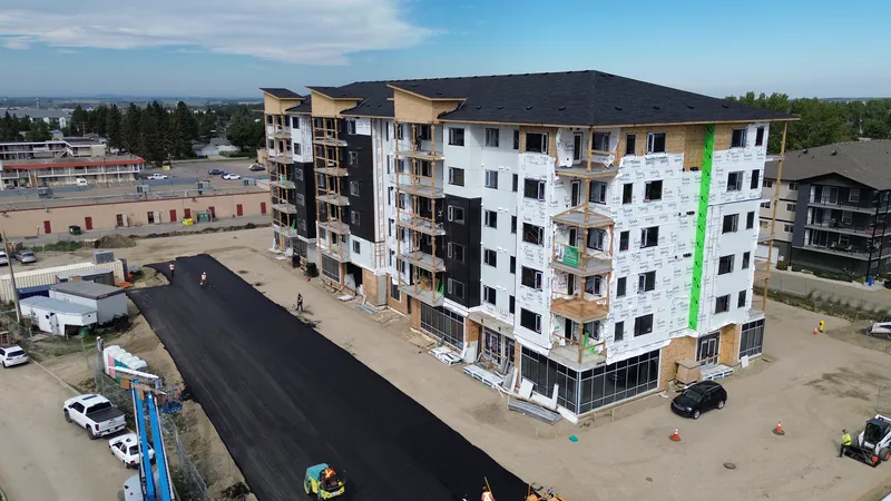 Aerial of a newly paved parking lot in front of a new apartment building