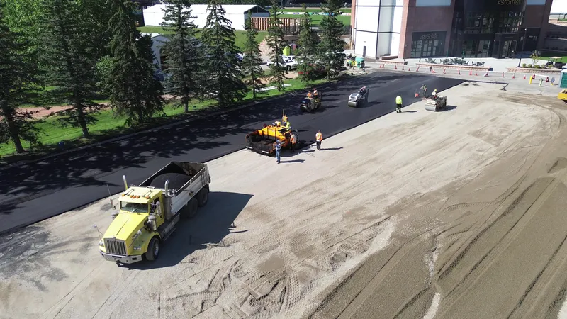 Calgary asphalt paving crew laying hot mix on a commercial parking lot